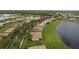 Aerial view of a residential area with lush landscaping, serene lakes, and a picturesque setting at 3617 Northwoods Dr, Kissimmee, FL 34746
