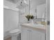 Well-lit bathroom featuring a white vanity with a stylish faucet and decorative plants at 3617 Northwoods Dr, Kissimmee, FL 34746