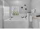 Bright bathroom featuring a luxurious soaking tub next to a window and a glass shower at 3617 Northwoods Dr, Kissimmee, FL 34746