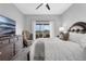 Well-lit bedroom features a TV, ceiling fan, furnishings, and sliding glass doors to the lanai at 3617 Northwoods Dr, Kissimmee, FL 34746