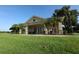 Exterior shot of a clubhouse with lush lawn and palm trees in a beautiful landscape at 3617 Northwoods Dr, Kissimmee, FL 34746