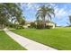 Lovely one-story home showcasing a vibrant green lawn and mature palm trees enhancing curb appeal at 3617 Northwoods Dr, Kissimmee, FL 34746