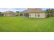 Beautiful backyard showcasing lush green grass and the home's screened-in lanai at 3617 Northwoods Dr, Kissimmee, FL 34746