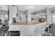 Bright kitchen featuring white cabinets, stainless steel appliances, and breakfast bar seating at 3617 Northwoods Dr, Kissimmee, FL 34746