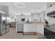 Bright kitchen featuring white cabinets, stainless steel appliances, and an open floor plan at 3617 Northwoods Dr, Kissimmee, FL 34746