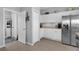 Bright kitchen featuring white cabinets, stainless steel appliances, and tile flooring at 3617 Northwoods Dr, Kissimmee, FL 34746