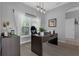 Home office with a sleek desk, modern lighting, and a view of the outdoors at 3617 Northwoods Dr, Kissimmee, FL 34746