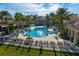 Expansive community pool area featuring multiple pools, lounge chairs, and lush landscaping at 3617 Northwoods Dr, Kissimmee, FL 34746