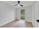 Bright bedroom with a ceiling fan, closet, fresh paint, and large window overlooking the yard at 3804 Anthony Ln, Orlando, FL 32822