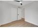 Bright bedroom features a ceiling fan, light wood floors, and a closet at 3804 Anthony Ln, Orlando, FL 32822