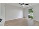 Bright and spacious bedroom with a large window offering natural light and wood-look floors at 3804 Anthony Ln, Orlando, FL 32822