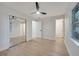 Spacious bedroom with a mirrored closet, wood-look floors, and a view to the bathroom at 3804 Anthony Ln, Orlando, FL 32822