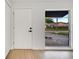 Bright entryway featuring wood-look floors, a large window, and a white front door at 3804 Anthony Ln, Orlando, FL 32822