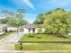 Beautifully landscaped single-story home with fresh exterior paint, manicured lawn, and a modern driveway at 3804 Anthony Ln, Orlando, FL 32822