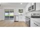 Well-lit kitchen with stainless steel appliances and a sliding glass door to the patio at 3804 Anthony Ln, Orlando, FL 32822