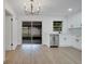 Modern kitchen features stainless steel appliances, white cabinets, and a sliding glass door to the patio at 3804 Anthony Ln, Orlando, FL 32822
