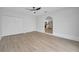 Bright living room boasts fresh paint, ceiling fan and views into the kitchen and light-colored modern flooring at 3804 Anthony Ln, Orlando, FL 32822