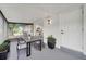 Covered patio features an outdoor dining area with a table and chairs, next to an outdoor doorway at 3804 Anthony Ln, Orlando, FL 32822