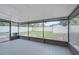 Covered, screened porch overlooks the grassy backyard and white fencing at 3804 Anthony Ln, Orlando, FL 32822