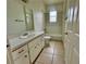 Bathroom includes a vanity with sink, tile flooring, and a shower over tub at 453 Alston Dr, Orlando, FL 32835