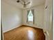 Bedroom features a ceiling fan, window with curtains, and wood-look laminate flooring at 453 Alston Dr, Orlando, FL 32835