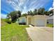 Charming single-Gathering home with manicured lawn, mature trees, and an attached one car garage at 453 Alston Dr, Orlando, FL 32835