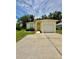 Charming single-Gathering home with manicured lawn, mature trees, and an attached one car garage at 453 Alston Dr, Orlando, FL 32835