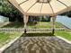 Backyard gazebo featuring neutral colored curtains and a brick-paved sitting area at 453 Alston Dr, Orlando, FL 32835