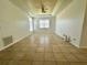 Spacious living room with a vaulted ceiling, fan, tile floors, and a large window at 453 Alston Dr, Orlando, FL 32835