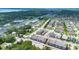 Expansive aerial view capturing a neighborhood with a mix of residential and commercial areas near a picturesque lake at 5103 Jones Rd, St Cloud, FL 34771