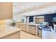 Open kitchen with stainless steel appliances, granite countertops, and a view of the living room at 5103 Jones Rd, St Cloud, FL 34771