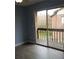 Spacious bedroom features hardwood floors and sliding glass door to balcony at 5144 Picadilly Circus Ct # 2, Orlando, FL 32839
