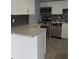 Well-lit kitchen features granite counters, white cabinets and stainless steel appliances at 5144 Picadilly Circus Ct # 2, Orlando, FL 32839