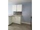 Bright kitchen features granite counters, white cabinets and tile backsplash at 5144 Picadilly Circus Ct # 2, Orlando, FL 32839