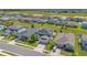 Wide aerial view showcases neighborhood with neat lawns and tidy landscaping on a bright day at 5225 Tuscany Ln, Davenport, FL 33897