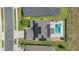 This aerial view showcases a home with solar panels and a refreshing backyard swimming pool at 5225 Tuscany Ln, Davenport, FL 33897