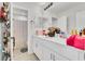 Bright bathroom featuring dual sinks, white cabinetry, and a shower with decorative curtain at 5225 Tuscany Ln, Davenport, FL 33897