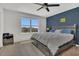 Well-lit bedroom with hardwood flooring, a large window, and a stylish accent wall at 5225 Tuscany Ln, Davenport, FL 33897