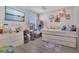 Bright bedroom with light wood floors, ample natural light, and fun, playful decorations at 5225 Tuscany Ln, Davenport, FL 33897
