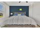 Spacious bedroom boasts a large window, hardwood flooring, and a modern blue accent wall at 5225 Tuscany Ln, Davenport, FL 33897