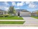 Charming two-story home featuring a lush lawn, inviting entrance, and convenient two-car garage at 5225 Tuscany Ln, Davenport, FL 33897