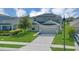 Two-story home with solar panels, well-maintained lawn and two-car garage; perfect for modern living at 5225 Tuscany Ln, Davenport, FL 33897