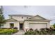 Charming two-story home with a two car garage, landscaped yard and welcoming front entrance at 5225 Tuscany Ln, Davenport, FL 33897
