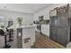 Well-lit kitchen featuring white cabinetry, a breakfast bar, modern appliances, and stylish flooring at 5225 Tuscany Ln, Davenport, FL 33897