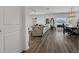 Open-concept living area featuring wood floors, comfortable seating, and dining area with sliding doors at 5225 Tuscany Ln, Davenport, FL 33897