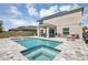 Stunning private pool and spa featuring a tiled trim and an inviting covered patio area at 5225 Tuscany Ln, Davenport, FL 33897