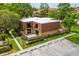 Aerial view of the townhome complex, ample parking, and beautiful landscaping with green grass and trees at 5251 Brook Ct # 242, Orlando, FL 32811