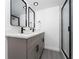 Modern bathroom boasts a double vanity with black fixtures and a glass-enclosed shower at 5251 Brook Ct # 242, Orlando, FL 32811