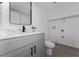 Updated bathroom with gray vanity, black hardware, and tile flooring. Washer and dryer hookups shown at 5251 Brook Ct # 242, Orlando, FL 32811