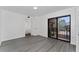 Bright bedroom featuring wood floors and a sliding glass door leading to the balcony at 5251 Brook Ct # 242, Orlando, FL 32811